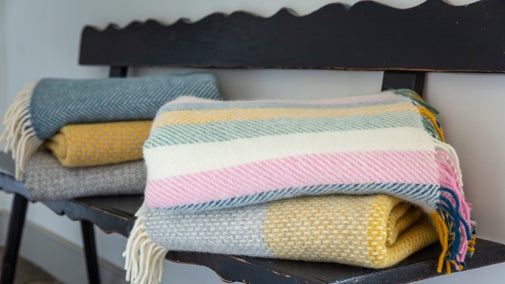 Folded throws in a selection of springtime colours